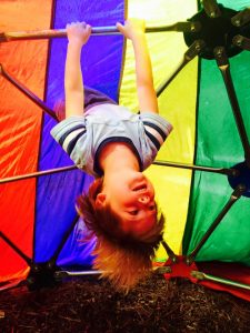 A boy plays on our outdoor jungle gym