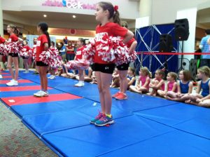 Young cheerleaders perform a routine at a meet