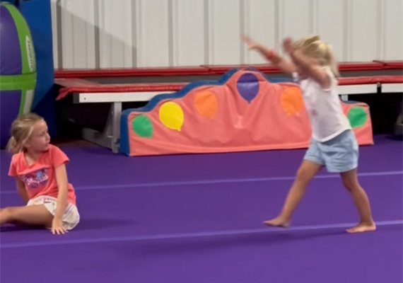 adc7 Preschool gymnast performs a tumbling move as another child watches during class at Carolina Gymnastics Academy.